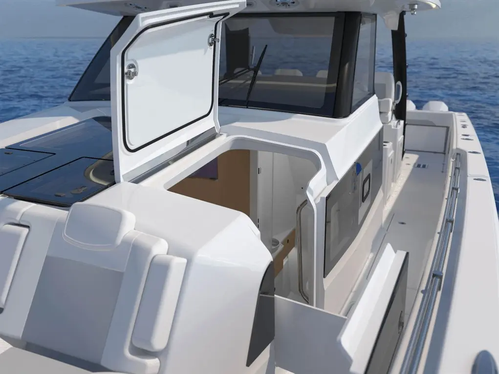 Spacious boat deck with an open compartment, featuring a glass door and a sleek design, overlooking calm blue waters.